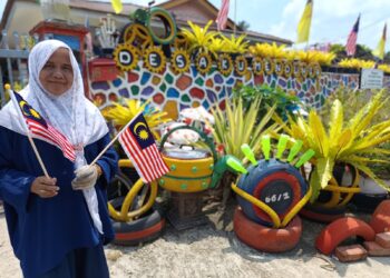HALIJAH Manhart membuat sendiri landskap rumahnya serta menambah hiasan bagi menceriakan lagi sambutan Hari Kebangsaan ketika ditemui di Felda Bukit Rokan, Tampin baru-baru ini.