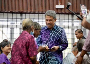 MOHAMAD Hasan yang juga Ahli Dewan Undangan Negeri (ADUN) Rantau menyerahkan bantuan kepada salah seorang penerima di Dewan Orang Ramai Rantau, Seremban, Negeri Sembilan.