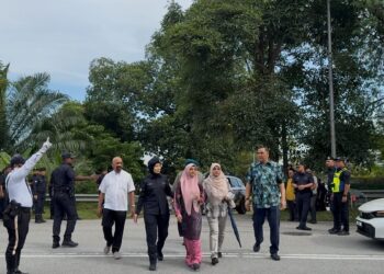 IBU Allahyarham, Ummu Haiman Bee Daulatgun diiringi peguamnya dan polis selepas selesai proses  penggalian semula kubur Syamsul Haris Shamsudin.