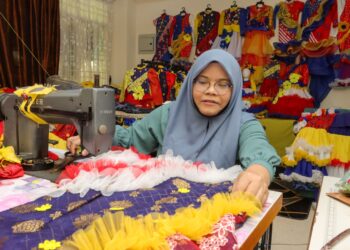 MAHANI Udit gigih menjahit pelbagai fesyen dan rekaan baju untuk
kanak-kanak sempena sambutan Hari Kebangsaan di Bayan Lepas,
Pulau Pinang. – UTUSAN/DANIAL SAAD