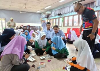 MOHD Syuhaimi Ab. Rahman (duduk, tengah) melihat pelajar melakukan aktiviti ketika menyertai Program STEM Profesor Ke Desa Inovasi Keusahawanan anjuran FKAB UKM di SMK Syed Abu Bakar, Kupang di Baling, Kedah hari ini.