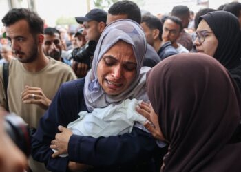 SEORANG wanita Palestin menangis sambil mendukung jenazah seorang bayi yang terbunuh dalam serangan Israel di Gaza City.-AFP