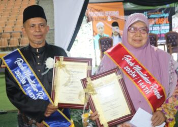 RAZAK Daud (kiri) dan Sharifah Zaleha Syed Abu Bakar bersama sijil Tokoh Maulidur Rasul peringkat Felda Wilayah Jengka.