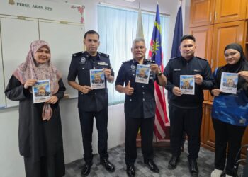 BAKRI Zainal Abidin (tengah) menunjukkan poster kejohanan lasak 'Terpaling Pahlawan Menara Condong'  yang akan berlangsung di Teluk Intan esok. - UTUSAN/AIN SAFRE BIDIN