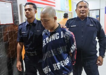 TERTUDUH, Nguyen Minh Hoa (tengah) diiringi oleh dua anggota polis ketika tiba di Mahkamah Majistret Butterworth, Pulau Pinang hari ini.-UTUSAN/DANIAL SAAD