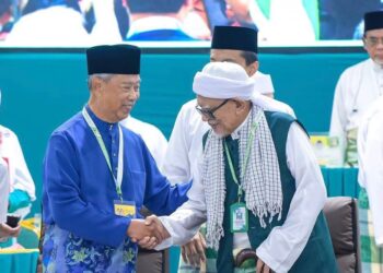 MUHYIDDIN Yassin bersalaman dengan Abdul Hadi Awang ketika menghadiri Muktamar Tahunan Pas ke-71 yang diadakan di Kompleks Pas Kedah, Kota Sarang Semut di Alor Setar, Kedah hari ini.