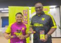 NAIM Jaafar (kiri) dan Zainal Abidin Hassan Mohd. Ali menunjukkan produk gel tenaga, Enegel keluaran syarikat 
mereka.