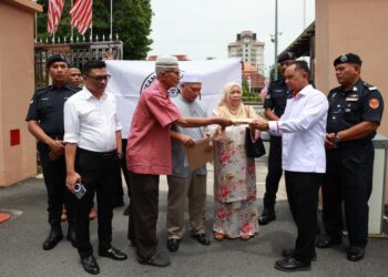 WAN Wan Abdul Rahman  Wan Yaacob (dua kiri) menyerahkan memorandum kepada Anas Rizuan Shamsuddin di pekarangan Kompleks Kota Darul Naim, Kota Bharu, Kelantan. - UTUSAN/KAMARUL BISMI KAMARUZAMAN