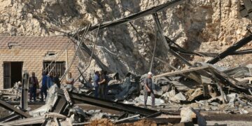 ORANG ramai meninjau kerosakan di sebuah kompleks pengeluaran simen sehari selepas siri serangan udara Israel di kampung Ansar, selatan Lubnan.-AFP