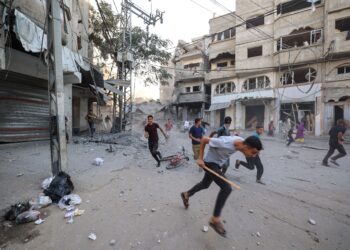 PENDUDUK Palestin melarikan diri ketika tentera Israel melancarkan serangan udara di tengah Gaza. – AFP