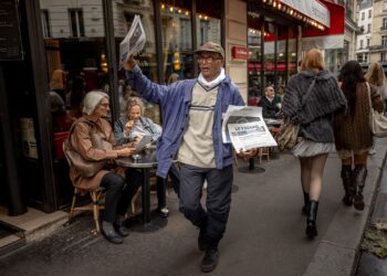 ALI Akbar berjalan kaki di sekitar kota Paris untuk menjual akhbar setiap hari. - AFP