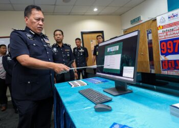 RUSDI Mohd Isa (kiri) menunjukkan portal Semak Mule Polis Diraja Malaysia (PDRM) pada sidang akhbar kejayaan operasi JSJK di Menara KPJ di sini hari ini. - UTUSAN/FARIZ RUSADIO