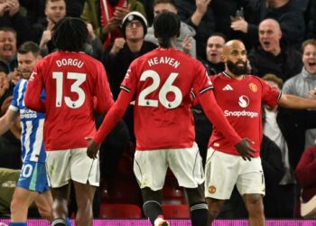 Pemain tengah Manchester United, Bryan Mbeumo (kanan) menggayakan aksinya selepas menjaringkan gol menentang Brighton, semalam. - AFP