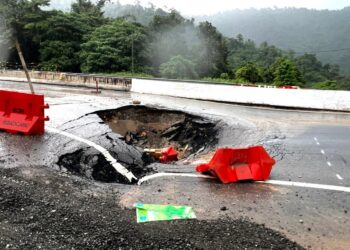 KEADAAN lubang benam di Kilometer 78, Jalan Gua Musang-Lojing, Gua Musang, Kelantan yang menyaksikan laluan itu ditutup kepada semua kenderaan. -  UTUSAN/AIMUNI TUAN LAH