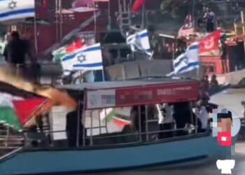 TANGKAP layar yang menunjukkan bendera Israel dikibarkan semasa program 500 Pelayaran Solidariti Kelantan Untuk Gaza di Sungai Kelantan, di Lembah Sireh, Kota Bharu, Kelantan pada Jumaat hanyalah gimik lakonan semula kekejaman rejim Zionis terhadap misi kemanusiaan Global Sumud Flotilla.