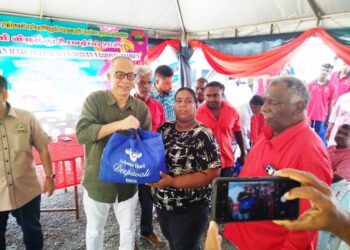 AMINUDDIN Md. Hanafiah (kiri) menyerahkan sumbangan Deepavali kepada tetamu yang hadir ke Majlis Sambutan Hari Deepavali 2025 IPF Bahagian Tambun di Ipoh, Perak hari ini. - UTUSAN/FADZIL ZAINOL