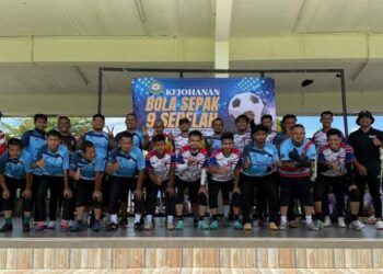 PASUKAN ‘Atletico Madrid’ (jersi warna biru) dan ‘Tottenham Hotspur’ bergambar sebelum perlawanan akhir Kejohanan Bola Sepak Sembilan Sebelah anjuran Persatuan Rangkaian Pemuda Pemudi Rawai (Rapera) di Padang Kampung Rawai, Marang, Terengganu, baru-baru ini.
