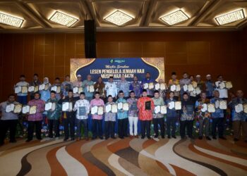 MOHD Na'im Mokhtar (belakang tengah) bergambar bersama Pengelola Jemaah Haji (PJH) selepas Majlis Serahan Lesen PJH Musim Haji 1447H di Sepang. - UTUSAN/FAISOL MUSTAFA