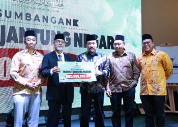 NOOH Gadut menyerahkan sumbangan zakat kepada Akmal Arief Mohd. Fauzi di Kuala Lumpur, kelmarin.