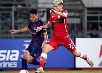 Arif Aiman Hanapi (kiri) bersaing dengan pemain Kuching City FC dalam aksi separuh akhir pertama Piala FA di Kuching, Sarawak, kelmarin. - IHSAN JOHOR SOUTHERN TIGERS