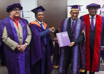 MOHD. Khairul Ab. Aziz (dua dari kiri) menerima ucapan tahniah daripada Dr Abdul Rahman Mohamed selepas Upacara Konvokesyen Ke-63 USM di George Town, Pulau Pinang, semalam. – UTUSAN/DANIAL SAAD