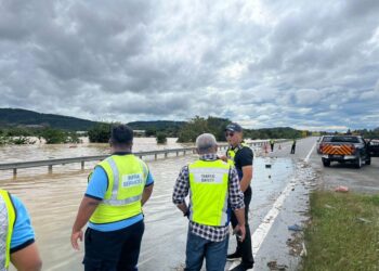 AIR yang melimpah ke permukaan jalan di Lebuhraya Utara-Selatan berhampiran Jitra di Kubang Pasu. - POLIS KUBANG PASU