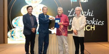 Pengerusi Eksekutif DXN Holdings Bhd., Datuk Lim Siow Jin (dua dari kiri), dan Pengarah Selasih Aman Sdn. Bhd., Wan Mustapha bin Wan Ismail (dua dari kanan), bertukar dokumen untuk merasmikan kerjasama mereka semasa pelancaran rasmi Telur Lingzhi.