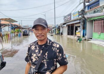 Pelancong Indonesia, Andri Atto merakam kenangan di Pekan Kukup Laut di Pontian, Johor yang digenangi air kerana air pasang besar ketika mengunjungi pekan tersebut semalam.