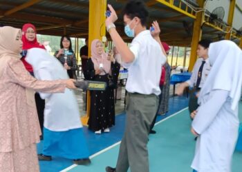 SEORANG guru menggunakan alat pengimbas logam pada calon SPM di SMK Sultan Ibrahim Johor Bahru, hari Ini. - UTUSAN/BAAZLAN IBRAHIM