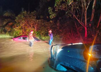 ANGGOTA Angkatan Pertahanan Awam Malaysia (APM) membantu menarik kereta yang tersangkut dalam longkang akibat banjir di Kampung Tersan, laluan Raub ke Lipis di Raub, Pahang.