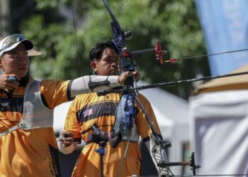 Atlet memanah, Quik Chern Xin (kiri) dan Muhammad Syafiq Busthamin beraksi dalam acara Recurve individu lelaki separuh akhir Sukan SEA Thailand 2025 di Sports Authority of Thailand, Bangkok, semalam. - UTUSAN/FARIZ RUSADIO