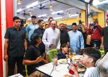 ANWAR Ibrahim menyantuni pelanggan ketika makan tengah hari di sebuah restoran di Sri Rampai,, Kuala Lumpur hari ini.-UTUSAN/AFIQ RAZALI