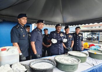 HUSSEIN Omar Khan (tengah) menunjukkan ketulan simen mengandungi dadah jenis MDMA yang dirampas dalam serbuan di stor penyimpanan dadah yang beroperasi di sebuah rumah banglo di Jalan Tun Dr Ismail, Ipoh, semalam.