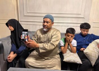 MUHAMMAD Kamarul yang ditemani tiga anaknya menunjukkan gambar Nadia dalam telefon pintar ketika ditemui di kediamannya di Kepala Batas, Pulau Pinang, malam semalam.