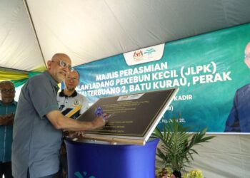 AHMAD Parveez Ghulam Kadir, Ketua Pengarah MPOB menandatangani plak Perasmian Jalan Ladang Pekebun Kecil (JLPK) Sungai Terbuang 2, Batu Kurau, Perak.
