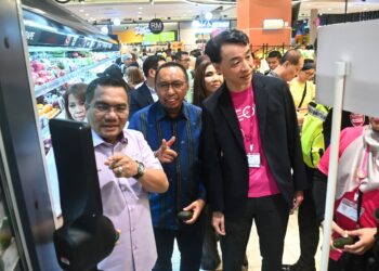 AMIZAR Abu Adam (kiri) meninjau dan melihat teknologi termasuk kecerdasan buatan (AI) yang digunakan di pasaraya Aeon Kuantan selepas merasmikan majlis pelancaran pasaraya berkenaan di Kuantan, Pahang.