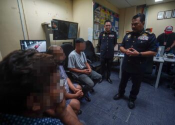 MUHAMMAD Kifli (kanan) ketika menahan tiga ulat teksi pada Ops Khas Ulat JPJ Negeri Selangor di KLIA Terminal 1. - UTUSAN/FAISOL MUSTAFA