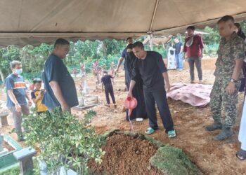 MOHD. Fikry Amri Abd. Halem menyiram air di pusara Maryam Al Khawla selepas selesai urusan pengebumian di Tanah Perkuburan Islam Pusara Abadi, Alor Gajah, Melaka hari ini.