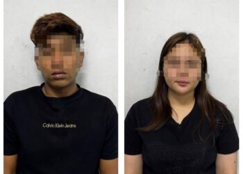 PASANGAN kekasih ditahan selepas bertindak melanggar kenderaan polis semasa pemeriksaan dilakukan di kawasan lampu isyarat tapak Perindustrian Padang Besar menghala ke Kangar, Perlis, pada Sabtu lalu. -UTUSAN