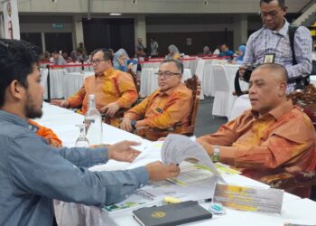 SAARANI Mohamad meneliti aduan rakyat pada Program Mesra Hari Bertemu Pelanggan di Stadium Indera Mulia, Ipoh hari ini.