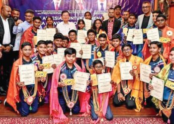 CHOW Kon Yeow (belakang, enam dari kiri) dan S. Sundarajoo (tiga dari kiri) bersama kumpulan pelajar yang diraikan dalam satu majlis di George Town, Pulau Pinang selepas berjaya meraih kejayaan pada World Robot Games (WRG) 2025 di Taiwan baru-baru ini. – UTUSAN/SAFINA RAMLI