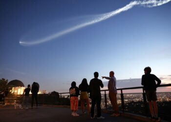 ORANG ramai melihat roket SpaceX Falcon 9 yang membawa 22 satelit internet Starlink ke angkasa selepas dilancarkan dari Pangkalan Angkasa Tentera Vandenberg di Los Angeles.-AFP