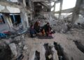 KELUARGA Palestin berkumpul dan menikmati hidangan berbuka puasa, di tengah kemusnahan di kem pelarian Bureij di tengah Gaza.- AFP