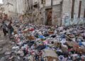 PENDUDUK tempatan berjalan melepasi timbunan sampah di sepanjang kawasan jalan di Havana, Cuba.-AFP