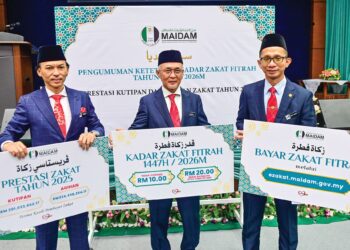 Zulkifli Ali (tengah) menunjukkan kadar zakat fitrah bagi tahun 2026 pada majlis Pengumuman Ketetapan Kadar Zakat Fitrah tahun 1447/2026M di Auditorium Jabatan Hal Ehwal Agama Terengganu (MAIDAM), semalam. -UTUSAN/PUQTRA HAIRRY