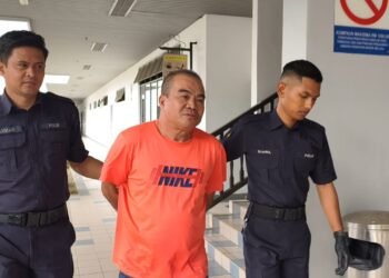 TERTUDUH, Yeo Khen Toon, 50, ketika dibawa keluar dari Mahkamah Majistret Ayer Keroh selepas didenda RM100 atas kesalahan mengeluarkan kata-kata kesat terhadap anggota polis di Taman Melaka Raya, dua minggu lalu. - UTUSAN/AMRAN ALI.