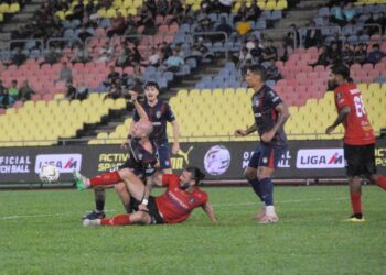PERTAHANAN Melaka FC menarik baju penyerang JDT, Joao Figueiredo dalam aksi suku akhir kedua Piala Malaysia di Stadium Hang Jebat malam ini.- UTUSAN/AMRAN MULUP