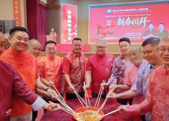 MOHD. Hairi Mad Shah (tengah) menggaul Yee Sang ketika menghadiri Majlis Ramah Tamah Sempena Tahun Baharu Cina Anjuran Persekutuan Tionghua Johor Bahru.