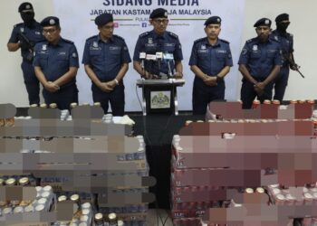 ROHAIZAD Ali (tengah) bersama sebahagian daripada minuman keras yang dirampas ketika sidang akhbar di Bagan Jermal, Butterworth, Pulau Pinang hari ini.-UTUSAN/DANIAL SAAD