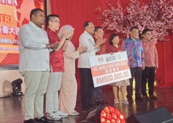 ANWAR Ibrahim menyerahkan cek peruntukan untuk kerja-kerja naik taraf kemudahan asas di Kampung Baru Kanthan, Ipoh, hari ini.